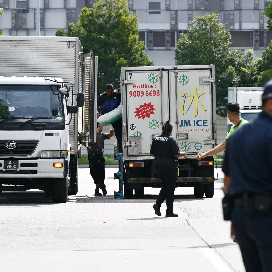 Workers from Jurong Marine Cold Storage that operates at 11 Jurong Fishery Port Road transporting ice from a supplier into vehicles waiting near their factory.