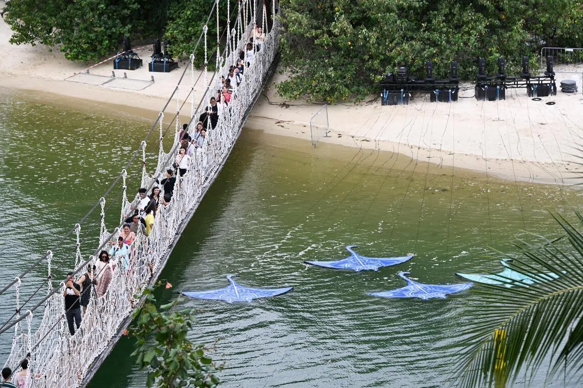 Manta ray installations on the water surface, which glow at night as guests cross the bridge to the Southernmost Point of Continental Asia.