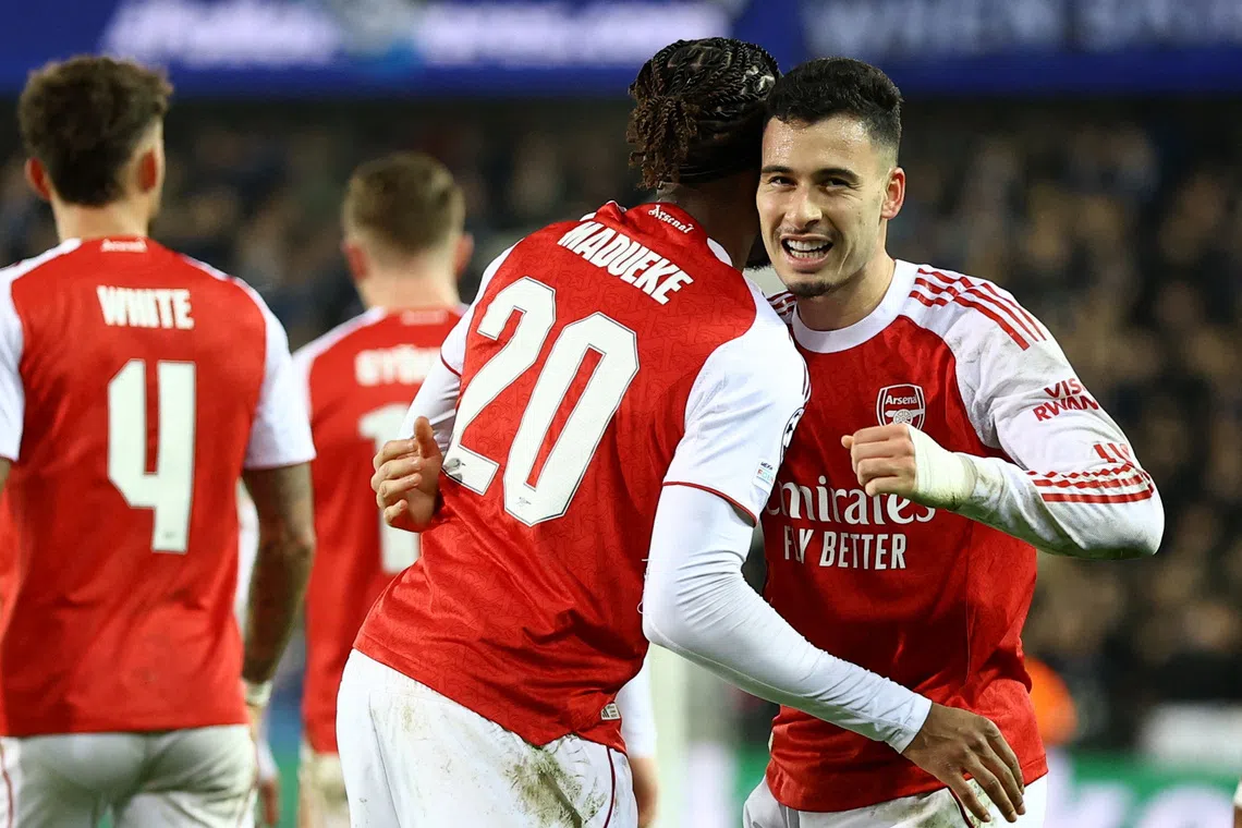 Soccer Football - UEFA Champions League - Club Brugge v Arsenal - Jan Breydel Stadium, Bruges, Belgium - December 10, 2025 Arsenal's Gabriel Martinelli celebrates scoring their third goal with Arsenal's Noni Madueke REUTERS/Yves Herman