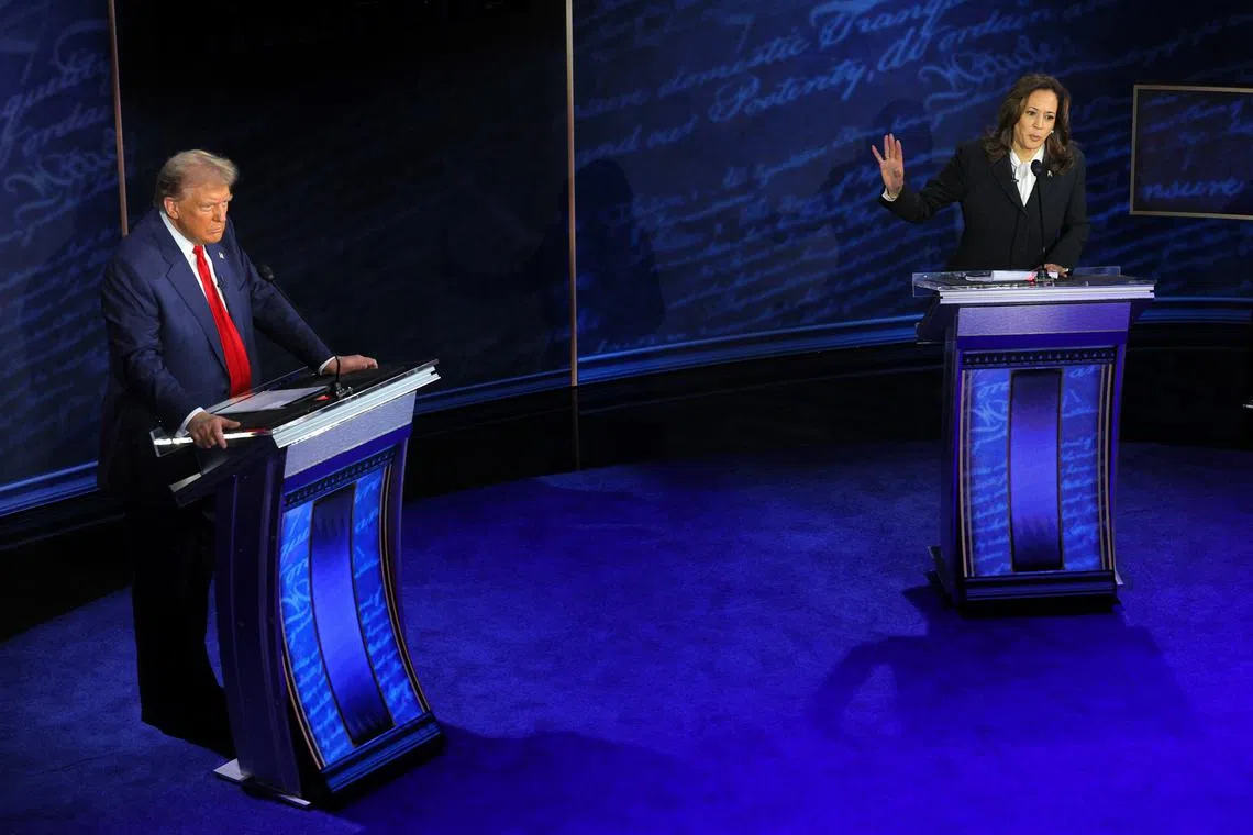 FILE PHOTO: Democratic presidential nominee, U.S. Vice President Kamala Harris speaks during a presidential debate hosted by ABC as Republican presidential nominee, former U.S. President Donald Trump listens, in Philadelphia, Pennsylvania, U.S., September 10, 2024. REUTERS/Brian Snyder/File Photo
