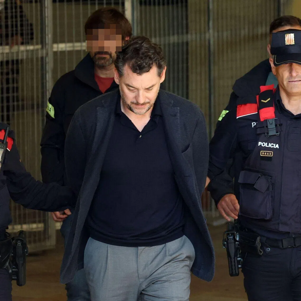 Mr Jonathan Andic being escorted to court in Martorell, near Barcelona, after his arrest on May 19. He was on a hike with his father, when the older Andic fell over 100m off a cliff.