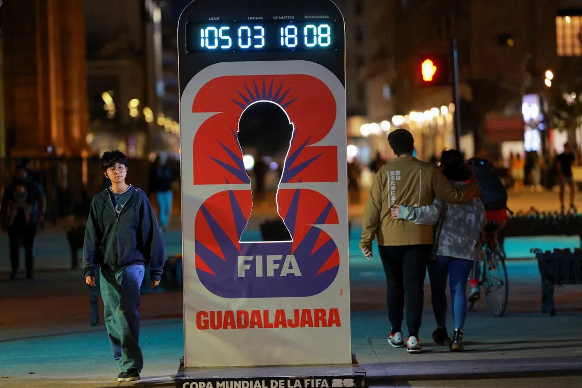 People walk past a countdown clock for the FIFA World Cup 2026 on a street, in Guadalajara, Mexico, February 25, 2026. REUTERS/Jose Luis Gonzalez
