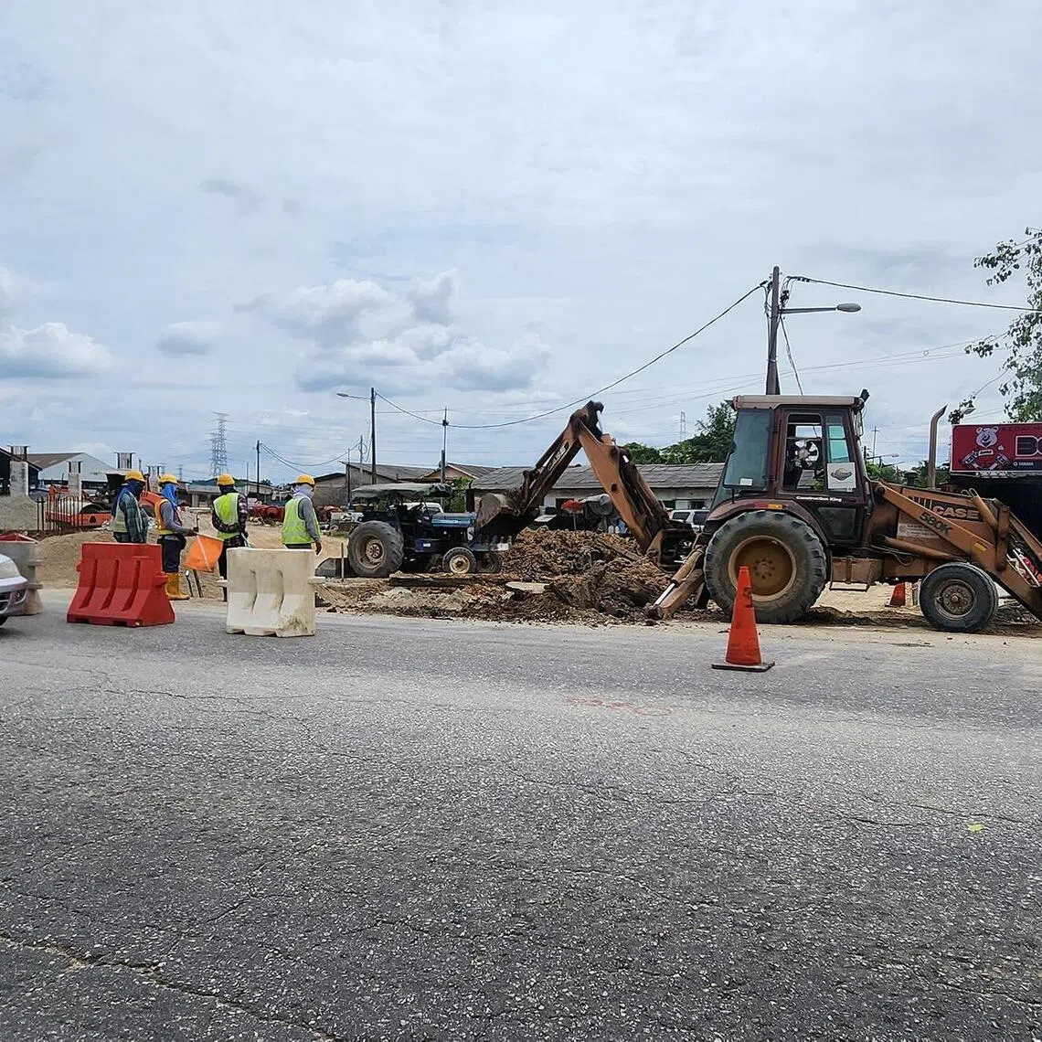 hzwce - Roadworks continue as a partially-completed flyover for a highway in Klang, Malaysia, looms in the background.

CREDIT: HAZLIN HASSAN