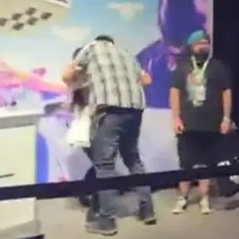 A video shared online shows a man quickly approaching Emiru before embracing her and leaning in for a kiss.