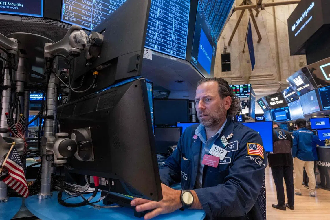 Traders work on the floor of the New York Stock Exchange, in New York City.