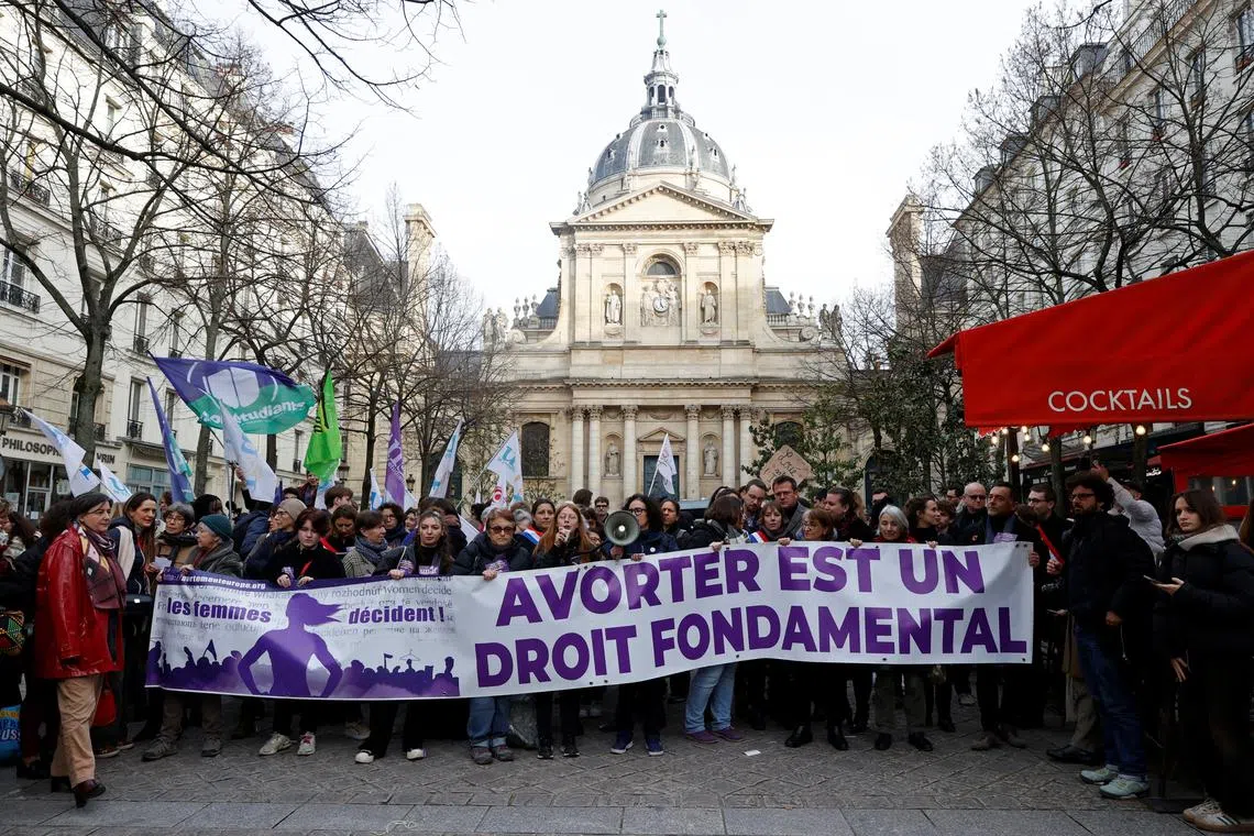 People hold a banner which reads \"Abortion is a fundamental right\" during a demonstration organised by the collective \"Abortion Europe, women decide\" as the French Senate examines a bill to include abortion in the Constitution, at the Place de la Sorbonne in Paris, France, February 28, 2024. REUTERS/Abdul Saboor