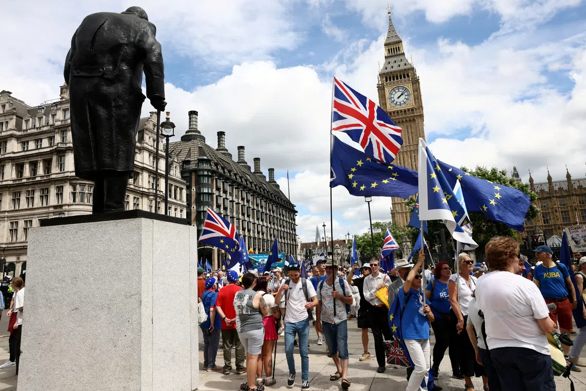 FILE PHOTO: People walk past the Elizabeth Tower, commonly known as Big Ben, during the National Rejoin March IV organised by National Rejoin March (NRM), marking ten years since Britain voted to leave the European Union in 2016 and calling for closer cooperation between Britain and Europe, in London, Britain, June 20, 2026. REUTERS/Jack Taylor/File Photo