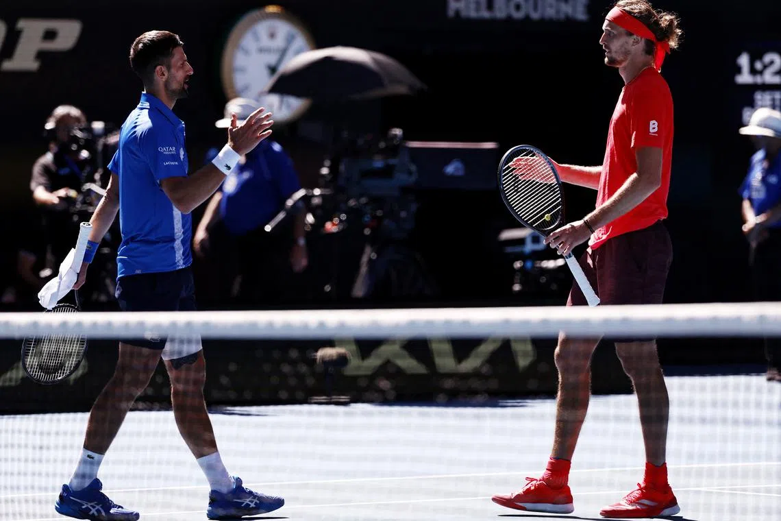 Tennis - Australian Open - Melbourne Park, Melbourne, Australia - January 24, 2025 Serbia's Novak Djokovic shakes hands with Germany's Alexander Zverev after retiring from their semi final match REUTERS/Tingshu Wang