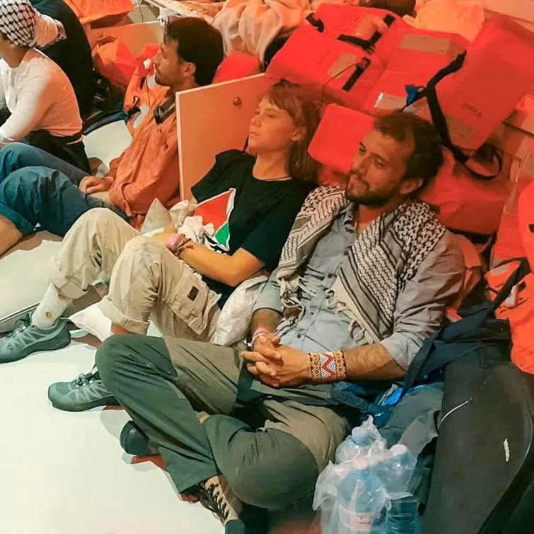Swedish activist Greta Thunberg (centre) and other activists being taken to Israel on a vessel that was part of the flotilla, which activists said carried food and medicine bound for Gaza.