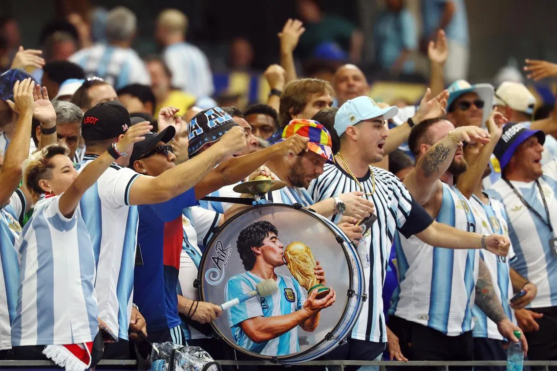 Soccer Football - FIFA World Cup 2026 - Group J - Argentina v Austria - Dallas Stadium, Arlington, Texas, U.S. - June 22, 2026 Argentina fans with a drum featuring a picture of Diego Maradona inside the stadium before the match REUTERS/Kai Pfaffenbach