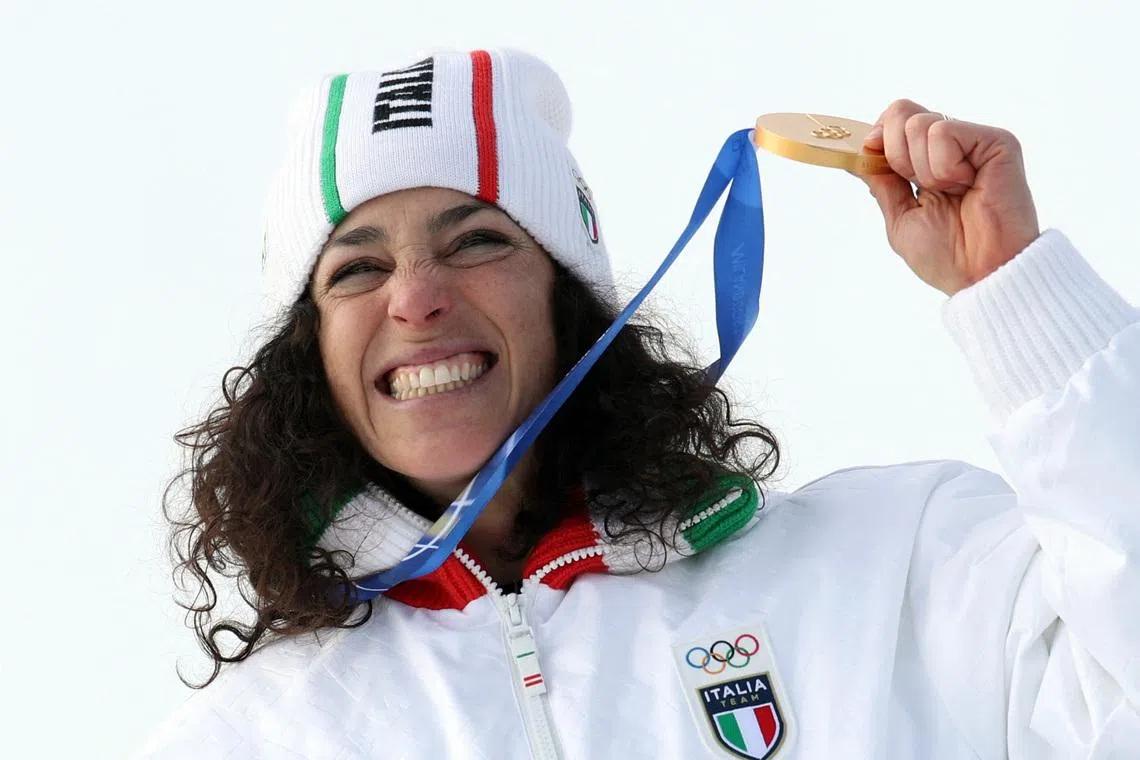 Milano Cortina 2026 Olympics - Alpine Skiing - Women's Super-G Victory Ceremony - Tofane Alpine Skiing Centre, Belluno, Italy - February 12, 2026. Gold medallist Federica Brignone of Italy celebrates winning the Women's Super-G during the victory ceremony. REUTERS/Leonhard Foeger