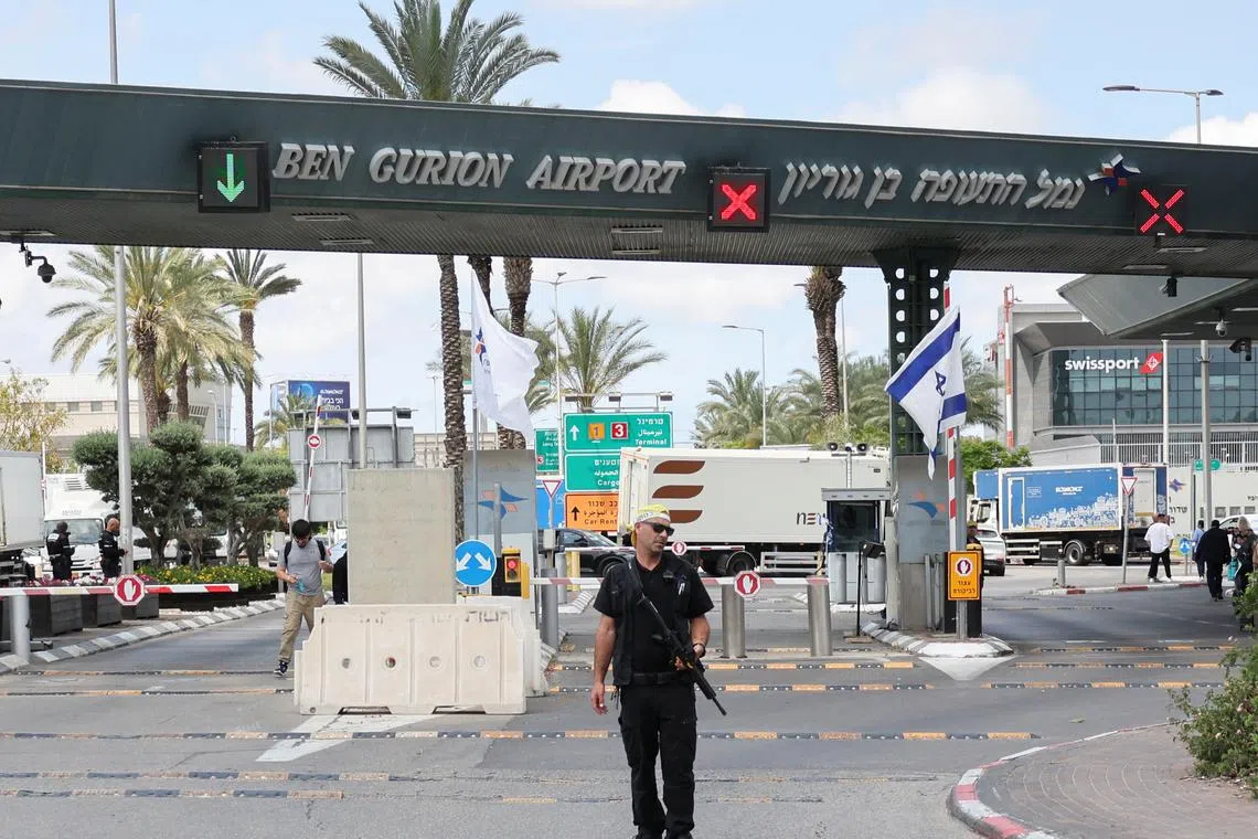 A security personnel stands at the entrance of Ben Gurion Airport following a missile attack launched from Yemen, in Tel Aviv, Israel May 4, 2025. REUTERS/Nir Elias