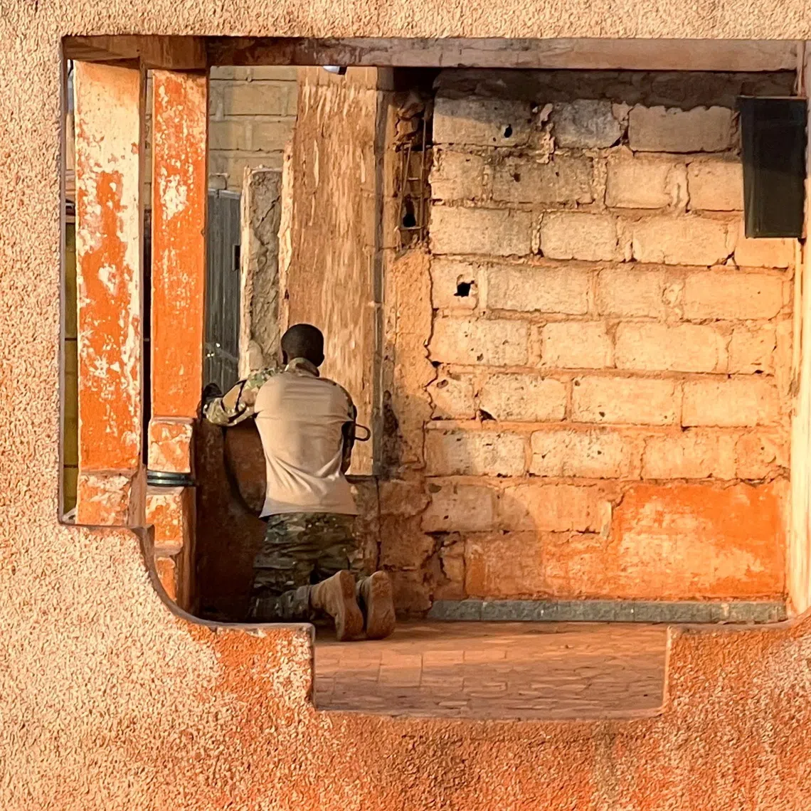 A Malian soldier stands in position with his weapon during an attack on Mali’s main military base Kati outside the capital Bamako, Mali, on April 25.