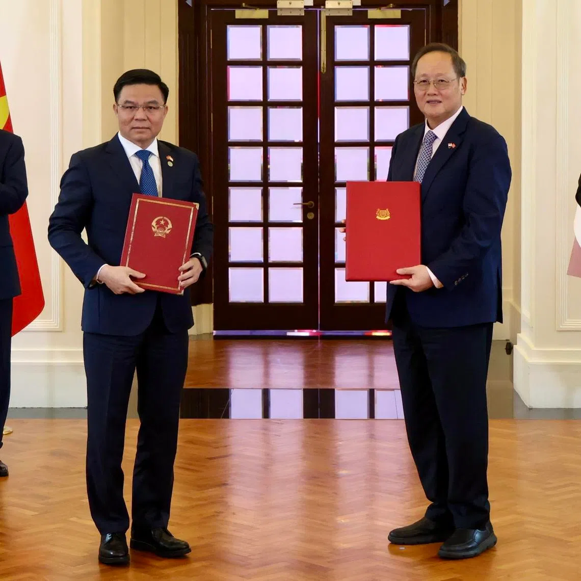 Singapore’s Minister-in-charge of Energy, Science and Technology Tan See Leng (second right) and Vietnam’s Minister of Industry and Trade Le Manh Hung (second left) signed an MOU on May 29, witnessed by Singapore Prime Minister Lawrence Wong (right) and Vietnamese President To Lam.