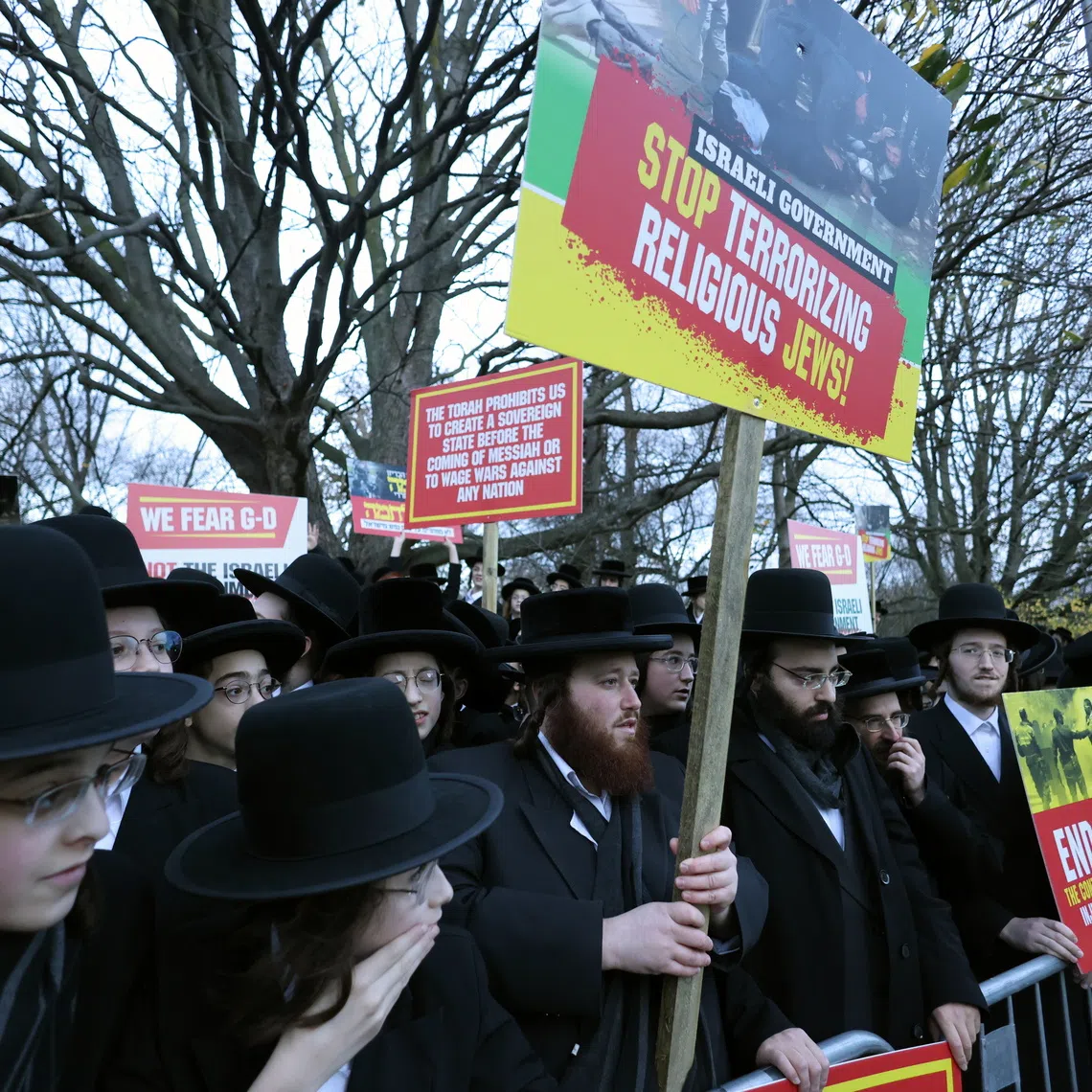 Members of the Orthodox Jewish community demonstrating outside Israel's embassy in London on Dec 11.