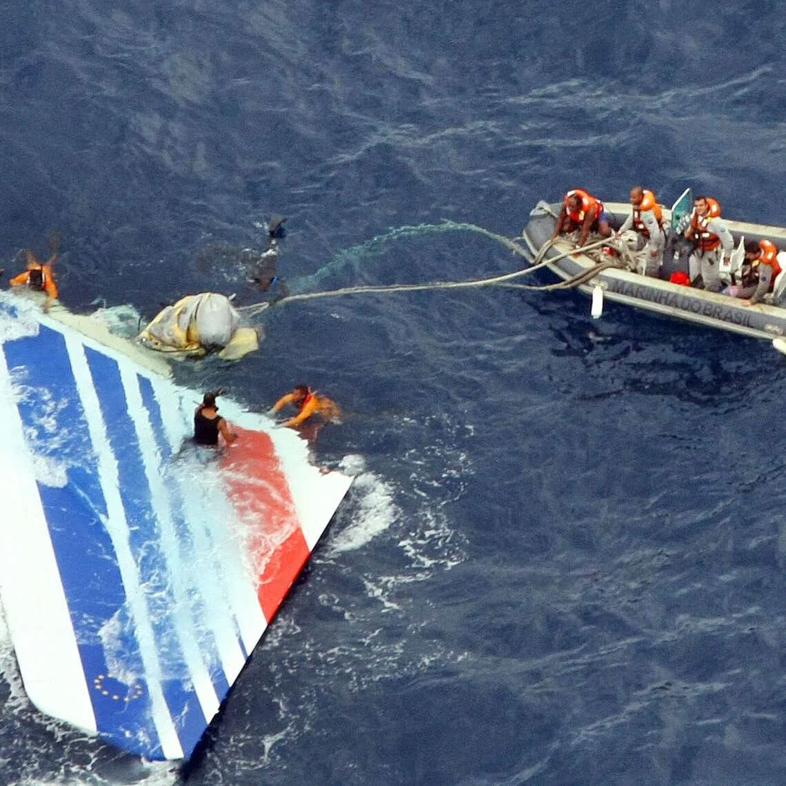 A file handout photo by the Brazilian Navy shows divers recovering part of the tail section from the Air France A330 aircraft that crashed in midflight over the Atlantic ocean on June 1, 2009.