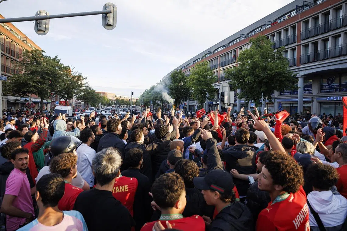 Fans of the Moroccan national soccer team celebrate in the Schilderswijk district of The Hague, The Netherlands, on June 30.