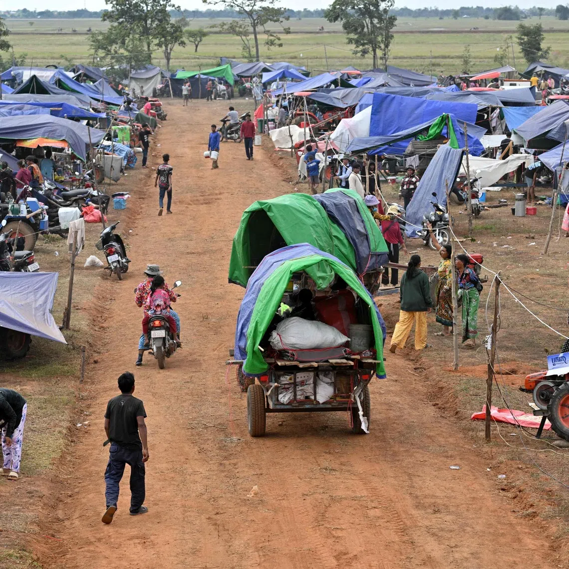 Displaced people arrive at a temporary camp in Cambodia's Oddar Meanchey province, on Dec 11.