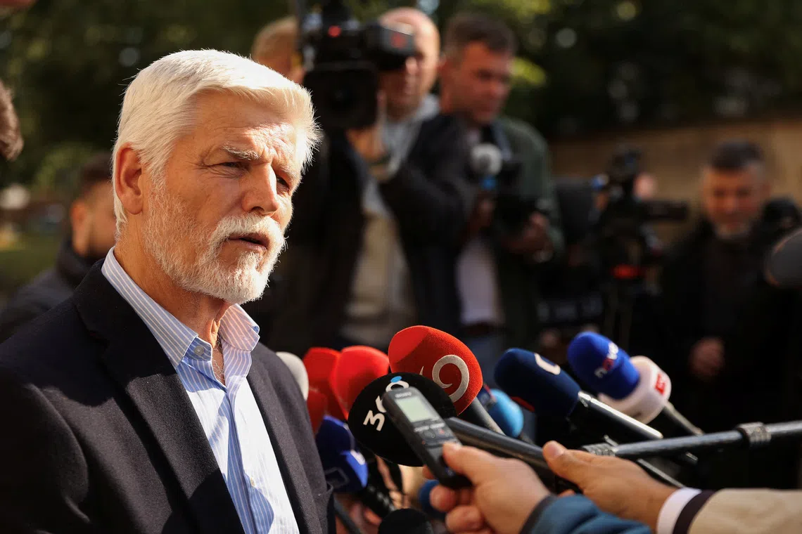 Czech President Petr Pavel speaks to members of the press, after casting his vote at a polling station during the country's parliamentary elections, in the village of Cernoucek, Czech Republic, October 3, 2025. REUTERS/Eva Korinkova