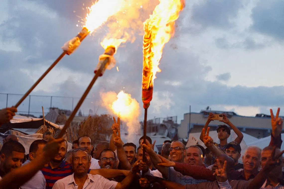 Palestinians lighting a torch during a mock World Cup event at the Martyr Muhammad al-Durra Stadium, which houses people displaced during the Israeli offensive, in Deir Al-Balah, in the central Gaza Strip, on June 7, 2026. 