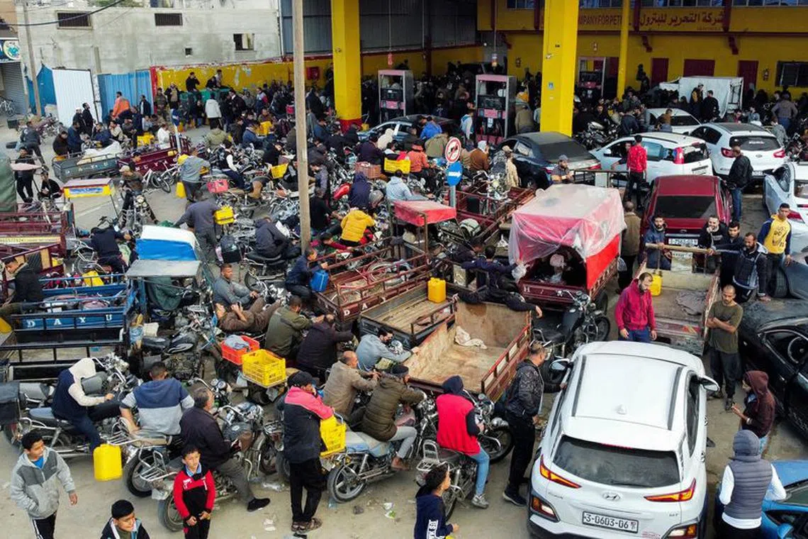 Palestinians wait to fill their cars with fuel during a temporary truce between Hamas and Israel, in Khan Younis, in the southern Gaza Strip November 28, 2023. REUTERS/Mohammed Salem/File Photo