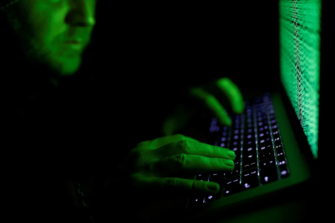 FILE PHOTO: A man types on a computer keyboard in front of the displayed cyber code in this illustration picture taken on March 1,  2017. REUTERS/Kacper Pempel/Illustration/ File Photo