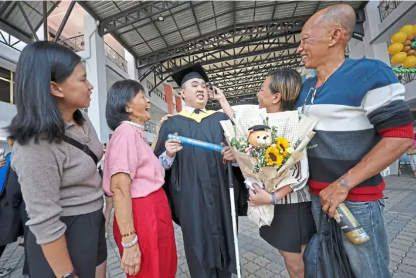 Mr Toh Khai Shern celebrates with his family at his convocation ceremony. 