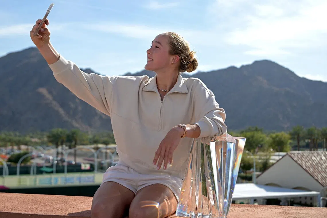 Mar 16, 2025; Indian Wells, CA, USA;  Mirra Andreeva (RUS) poses with the championship trophy after defeating Aryna Sabalenka (not pictured) in the womenÕs final of the BNP Paribas Open at the Indian Well Tennis Garden. Jayne Kamin-Oncea-Imagn Images