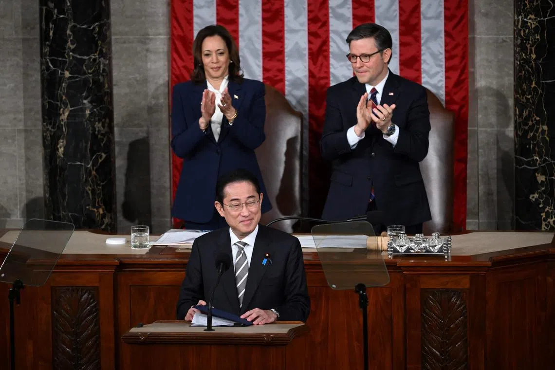 US Vice-President Kamala Harris and House Speaker Mike Johnson applaud Japanese Prime Minister Fumio Kishida after he addressed a joint meeting of Congress at the US Capitol in Washington, DC.