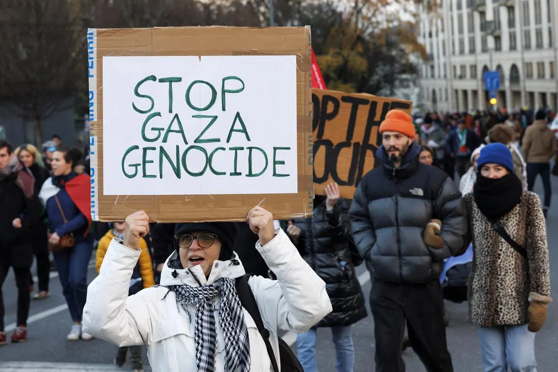 A Protester with a placard 'Stop Gaza Genocide' takes part in a rally in support of Palestinian people on Dec 26.