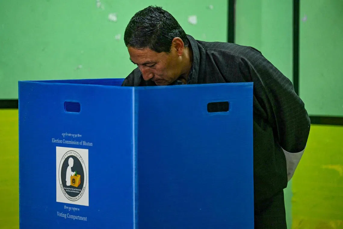 A voter casts his vote at a polling station during general elections in Thimphu on Jan 9.