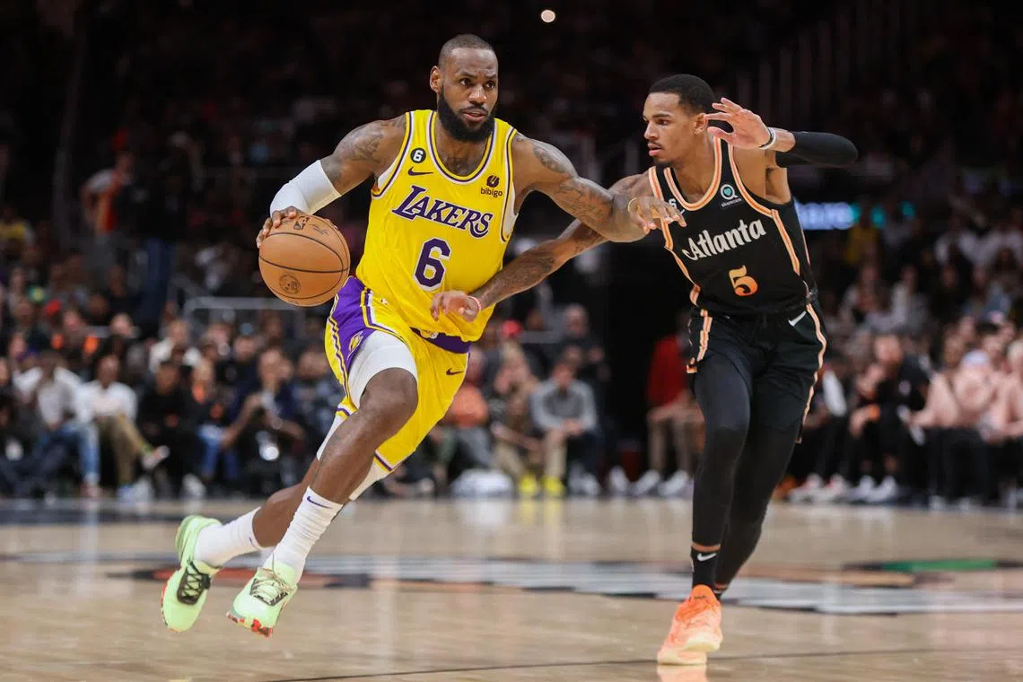 Los Angeles Lakers forward LeBron James is defended by Atlanta Hawks guard Dejounte Murray in the second half at State Farm Arena.
