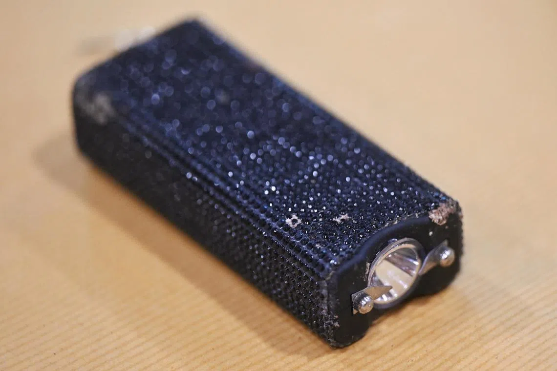 The black, rectangular stun device resembled a flashlight and emitted electricity from two prongs.