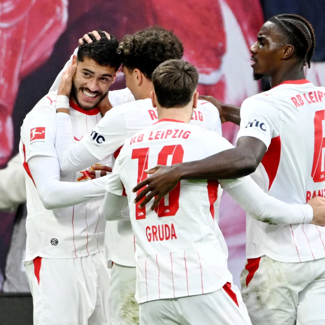 Soccer Football - Bundesliga - RB Leipzig v Elversberg - Red Bull Arena, Leipzig, Germany - October 24, 2026 RB Leipzig's Romulo celebrates scoring their second goal with teammates REUTERS/Annegret Hilse