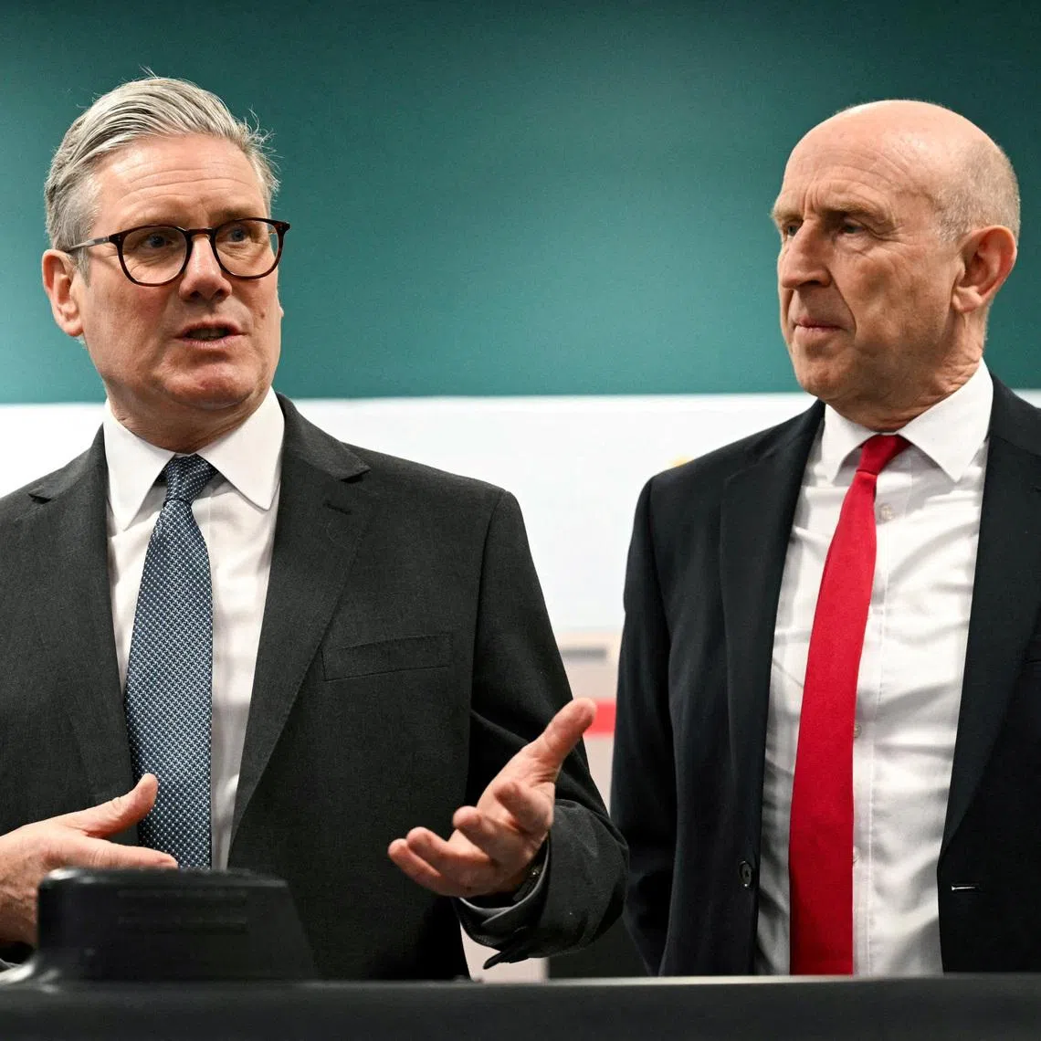 FILE PHOTO: Britain's Prime Minister Keir Starmer and Britain's Defence Secretary John Healey meet with BAE system apprentices during a joint visit in Barrow-in-Furness, Britain, on March 20, 2025.     OLI SCARFF/Pool via REUTERS/File Photo