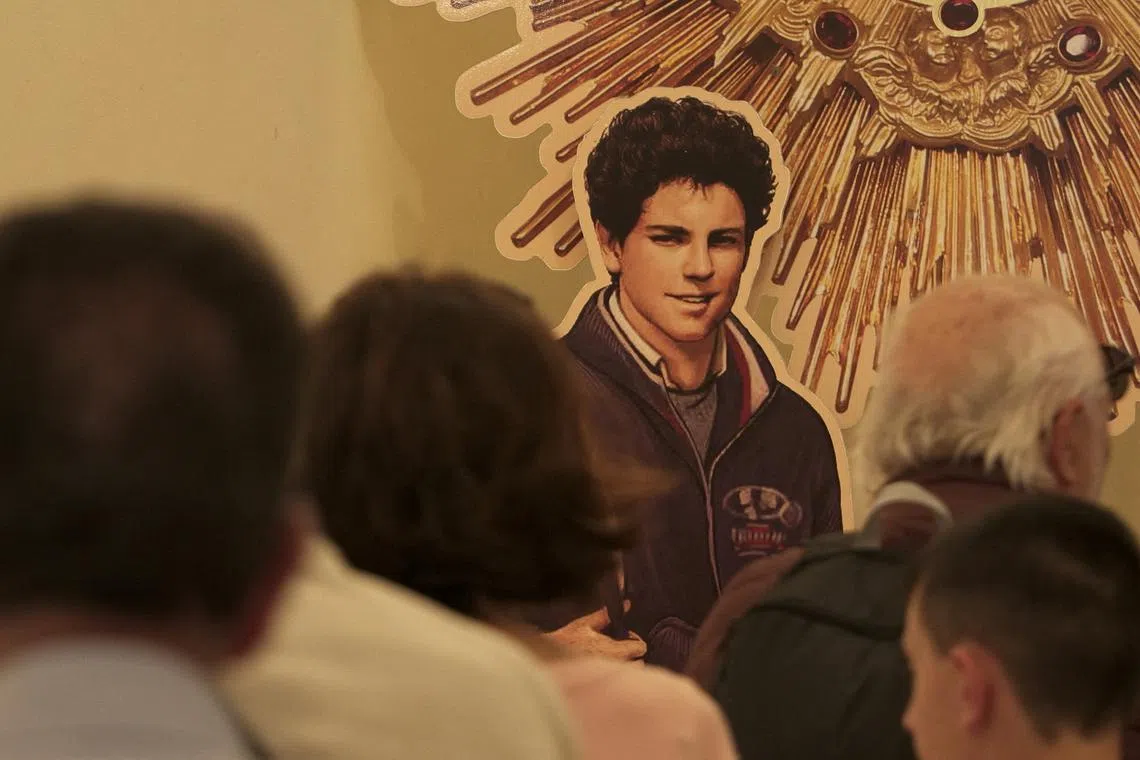 People visit the tomb of Carlo Acutis, who died of leukemia in 2006 aged 15, in the Church of Santa Maria Maggiore in Assisi, Italy, May 26, 2024. REUTERS/Matteo Berlenga/File Photo
