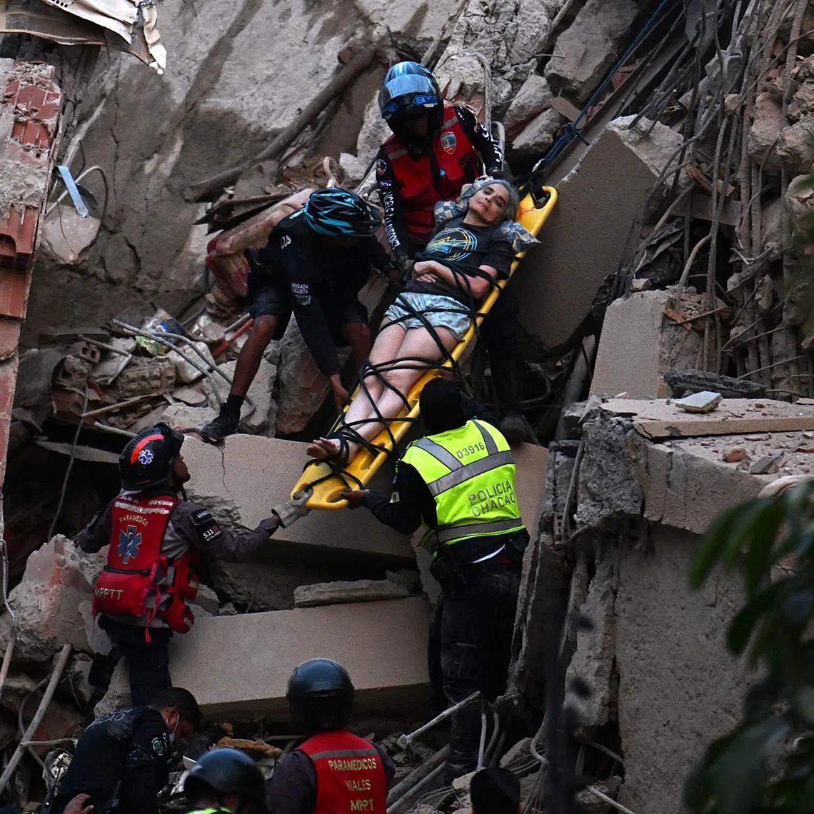Rescue workers carry a person on a stretcher out of a collapsed building following an earthquake in Caracas on June 24, 2026. A magnitude 7.1 earthquake struck Venezuela on Wednesday, the United States Geological Survey (USGS) reported, triggering panic in Caracas, according to AFP journalists. The tremor, which was followed by several aftershocks, was also felt in Colombia. (Photo by Juan BARRETO / AFP)