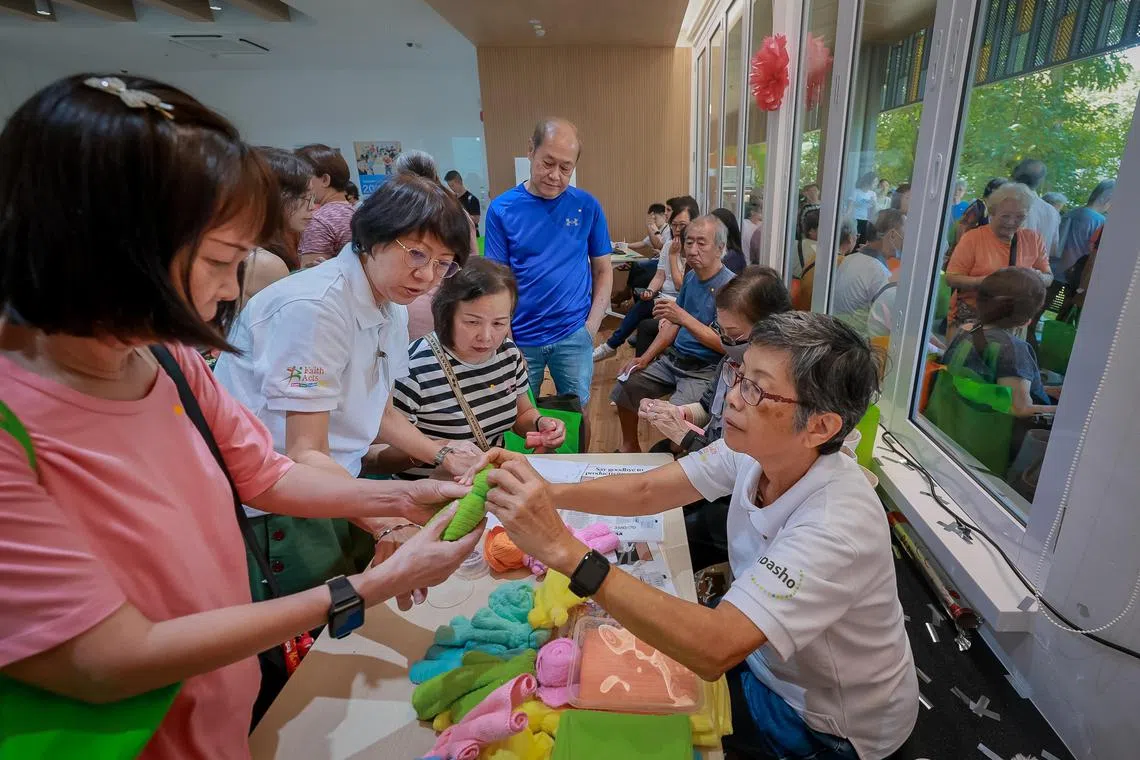 Elderly attendees making a bear from small cloth towels during the official opening of FaithActs Margaret Drive Centre, March 30, 2024.