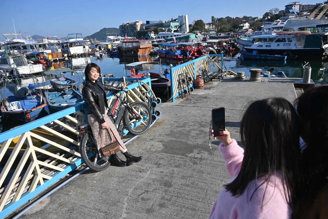 Mainland Chinese tourists taking photos in the Sai Kung district of Hong Kong on Jan 30, 2023.