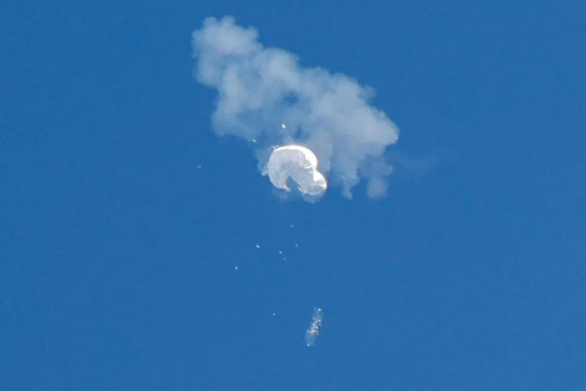 The suspected Chinese spy balloon drifts down to the ocean, after being shot down off the US coast, in Surfside Beach, South Carolina.