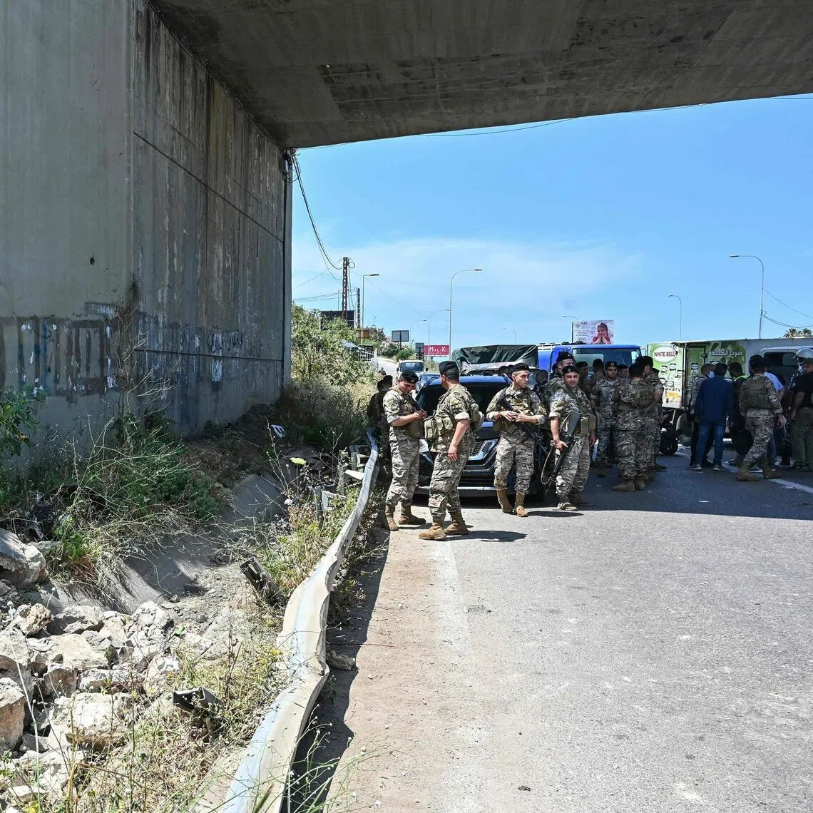 Lebanese soldiers secure the site of an Israeli drone strike that killed the passengers of a vehicle on the Khaldeh highway at the southern entrance to Beirut on June 3.