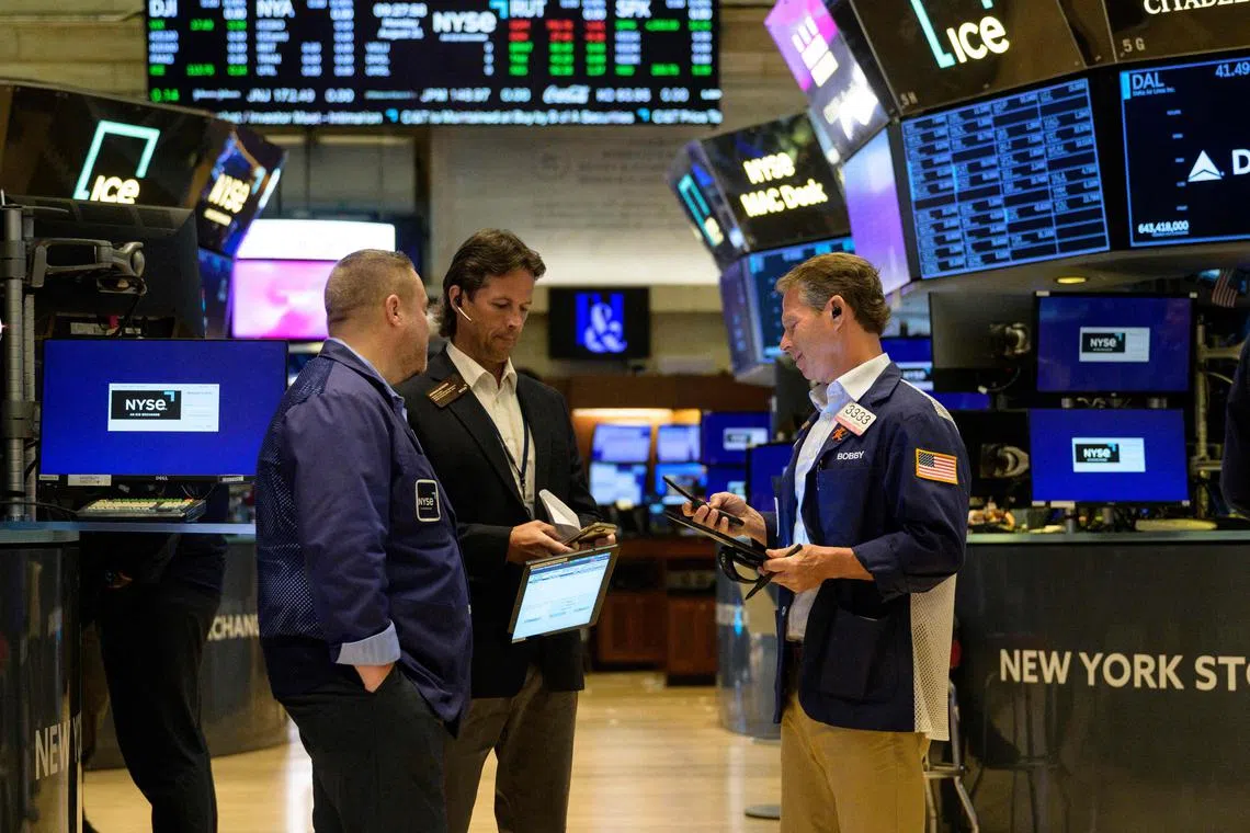 Traders work on the floor of the New York Stock Exchange during the opening bell, in New York City.