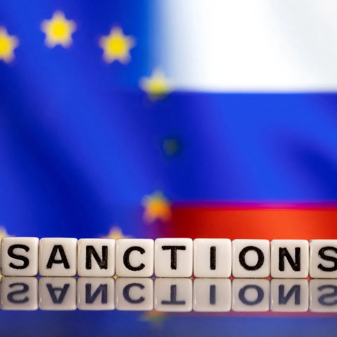 Plastic letters arranged to read \"Sanctions\" are placed in front of EU and Russia's flag colors in this illustration taken February 25, 2022. REUTERS/Dado Ruvic/Illustration