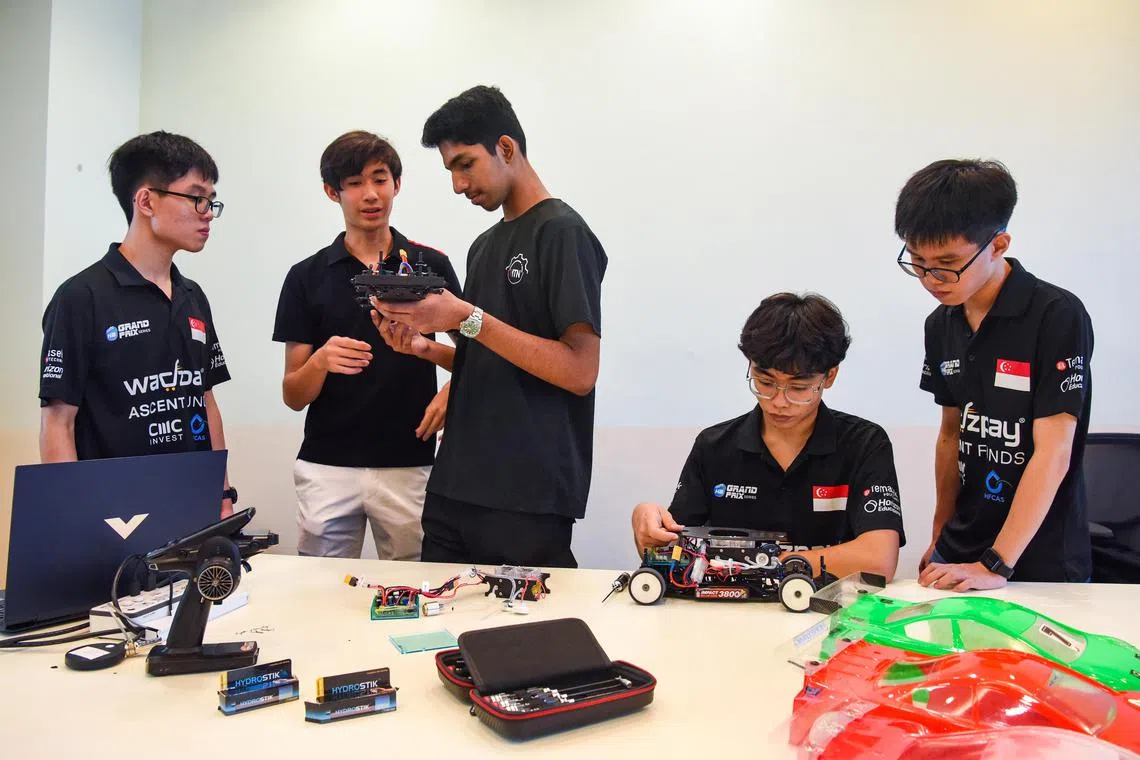 ST20230823_202392266293-Eugene Tan-Cheryl Tan-ctnhydrogen/ (from left) The Temasek Polytechnic team Lee Yu Sen,17 , Ethan Cheng,17 , Arjun Haridas,17 , Joshua Kee,17 , Lee Yu Xiang,17 , working on their car for the Hydrogen Grand Prix on August 23, 2023./ (ST PHOTO: EUGENE TAN)