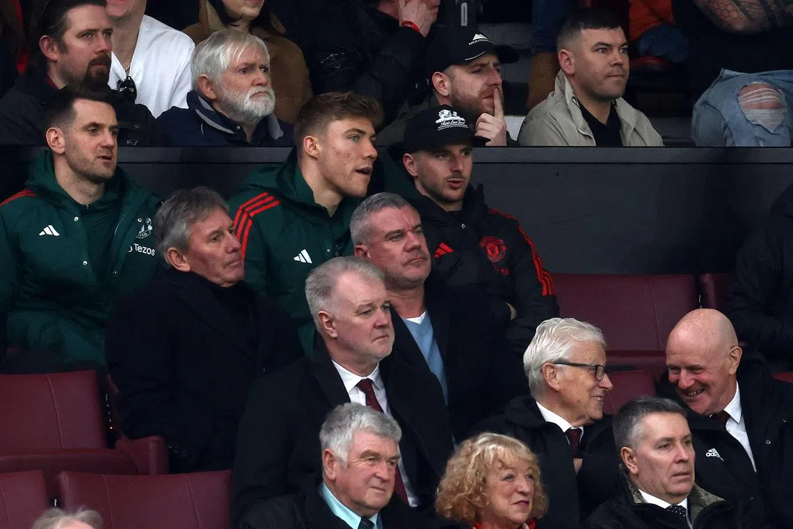 Manchester United's Mason Mount (centre) and Rasmus Hojlund watching from the stands as United play Fulham, at Old Trafford, on Feb 24, 2024.