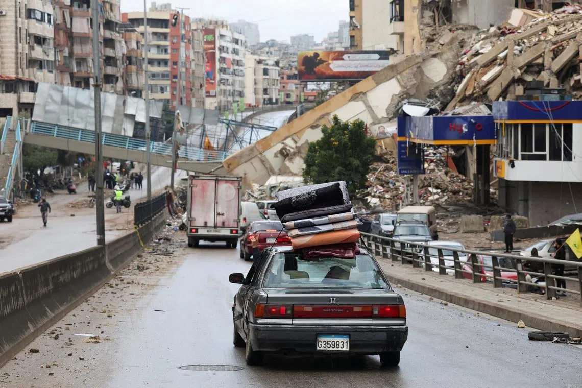 A vehicle transporting mattresses drives past a damaged pedestrian bridge in Beirut's southern suburbs, after a ceasefire between Israel and Hezbollah took effect, Lebanon November 27, 2024. REUTERS/Mohamed Azakir