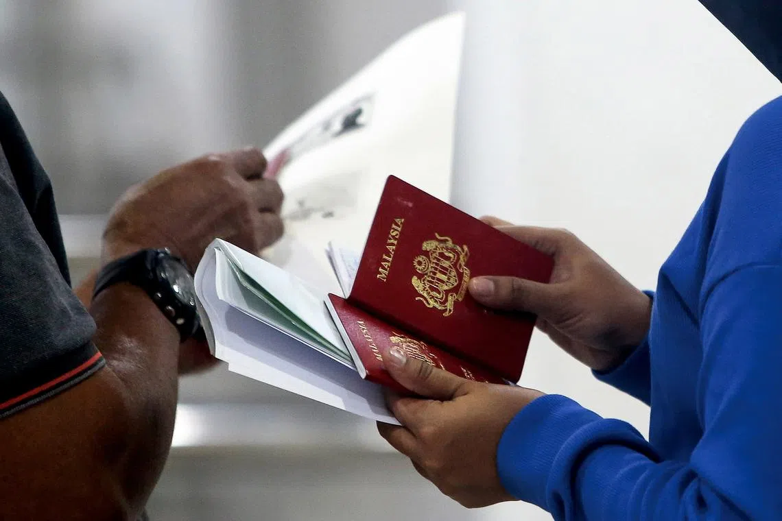 2 immigration officers in Malaysia nabbed for masterminding online passport renewal syndicate