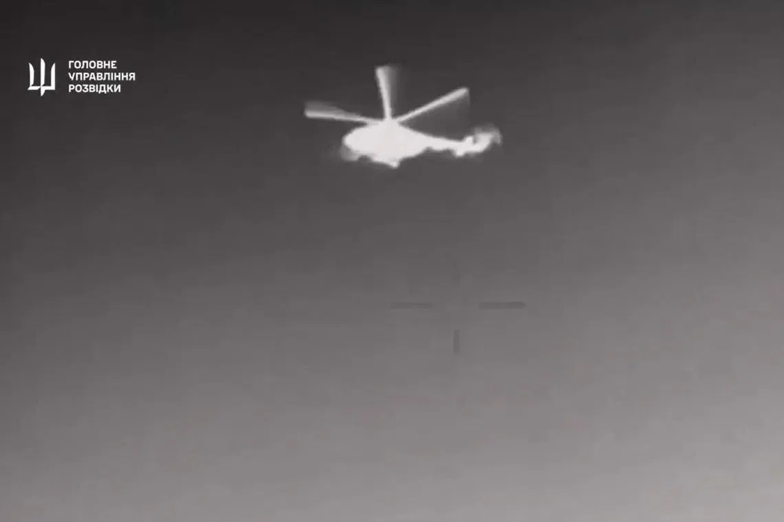 In grainy footage released by Ukraine's GUR spy agency, a helicopter flying over water could be seen targeted by several projectiles.