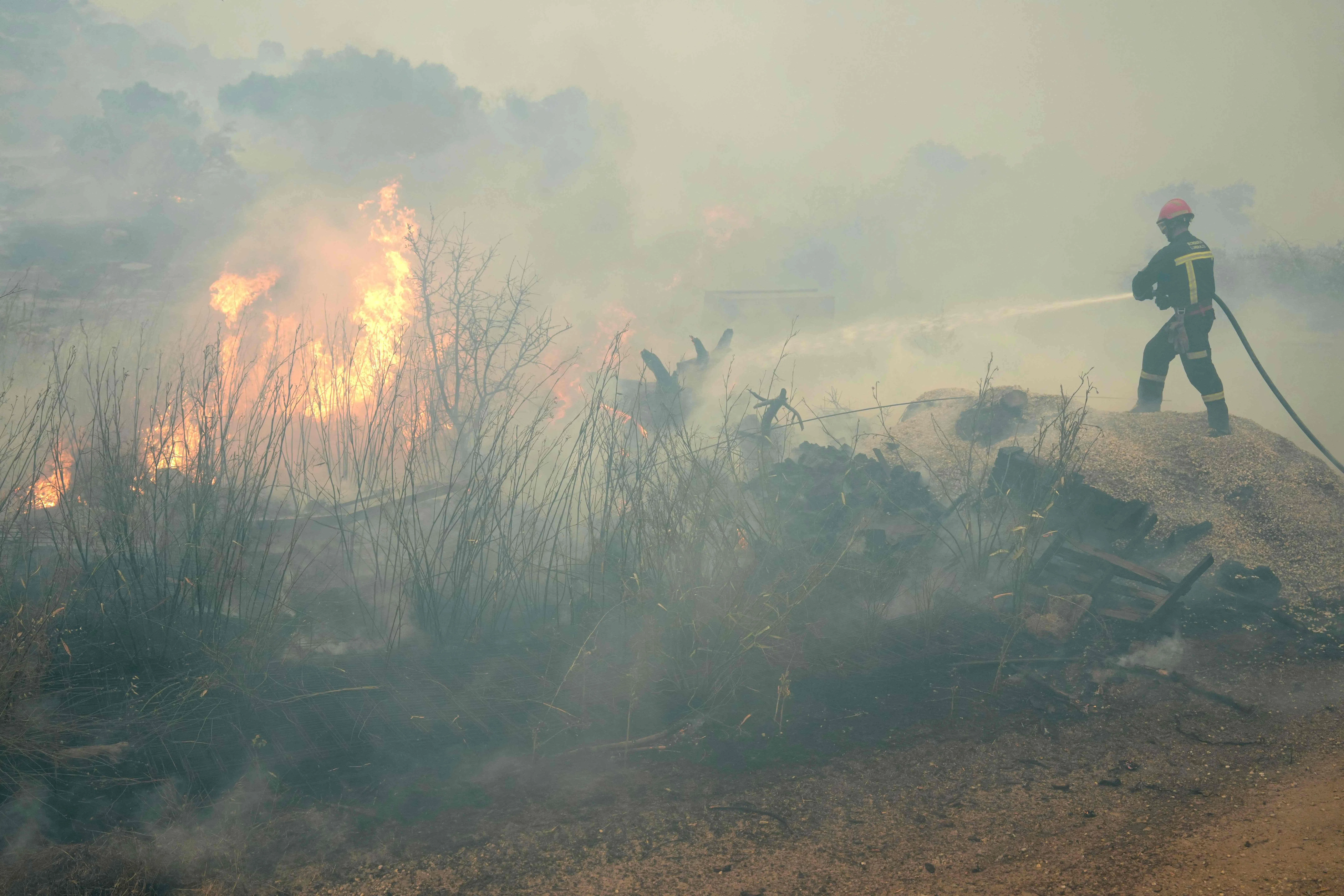 A firefighter battling a wildfire 80km west of Madrid on July 24.