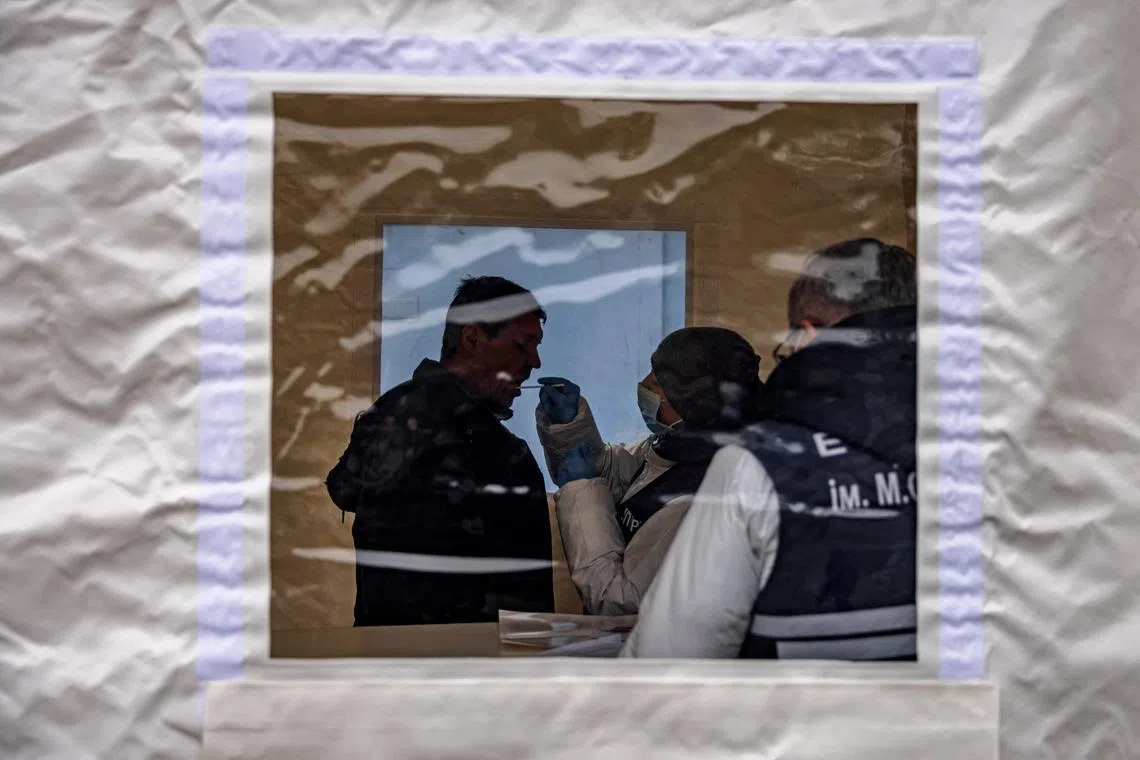 A man has a DNA sample collected at a mobile laboratory in the Ukrainian town of Izyum, for the identification of his loved ones, on Nov 4, 2022.